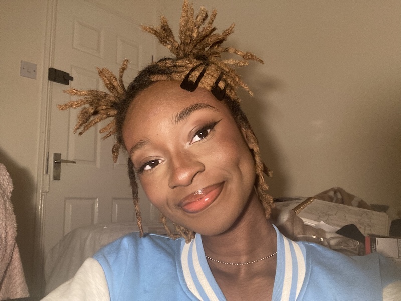 A picture of Illustration student Promise Oladimeji, who is smiling